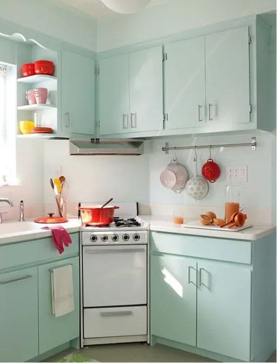 mint-colored cabinets and some bold tableware are all you need to create a retro feel in the kitchen