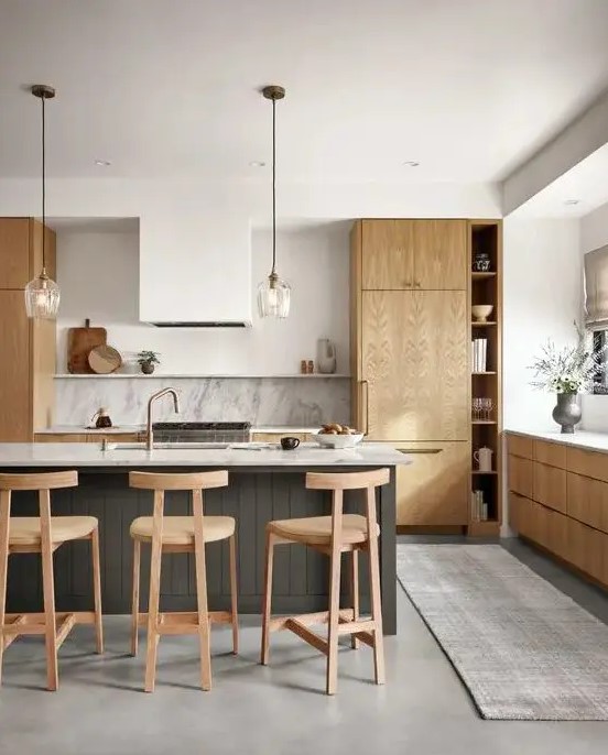 a contemporary kitchen with light stained cabinets, a white hood, a stone backsplash and countertops plus a grey planked kitchen island