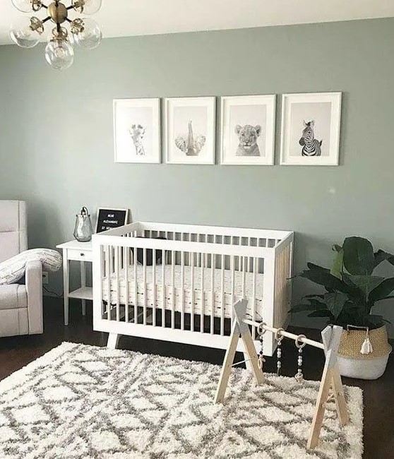 ديكورات مودرن 36-a-cozy-and-cute-nursery-with-a-sage-green-accent-wall-white-furniture-a-potted-plant-a-chic-chandelier-and-a-lovely-printed-rug