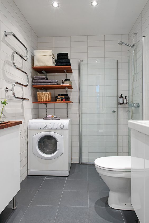 a small minimalist bathroom with a shower space, a washing machine and shelves, a floating vanity and a console table