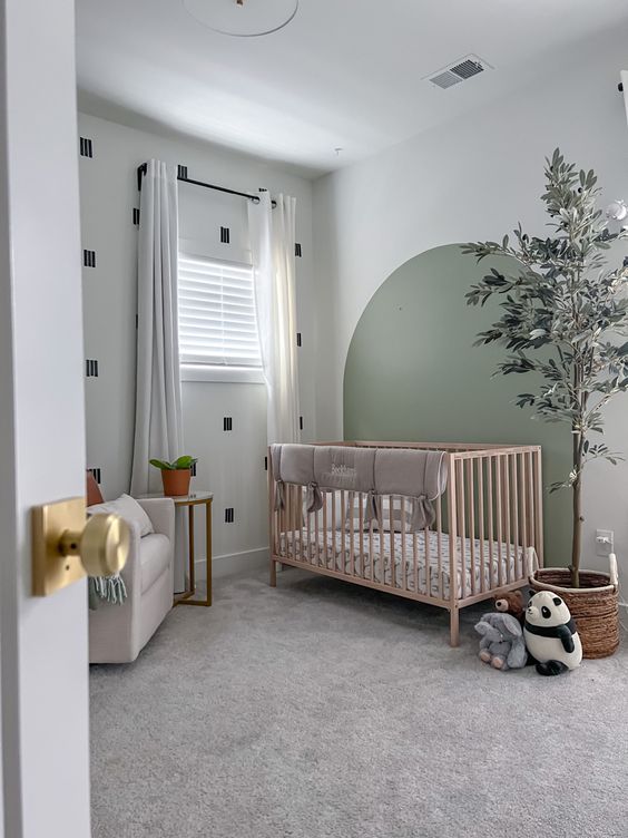 ديكورات مودرن 39-a-small-nursery-with-a-printed-wall-and-a-sage-green-accent-a-stained-crib-with-neutral-bedding-a-potted-tree-and-some-toys