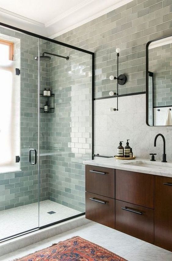 ديكورات مودرن 47-a-farmhouse-sage-green-bathroom-clad-with-subway-tiles-a-dark-stained-floating-vanity-and-black-fixtures