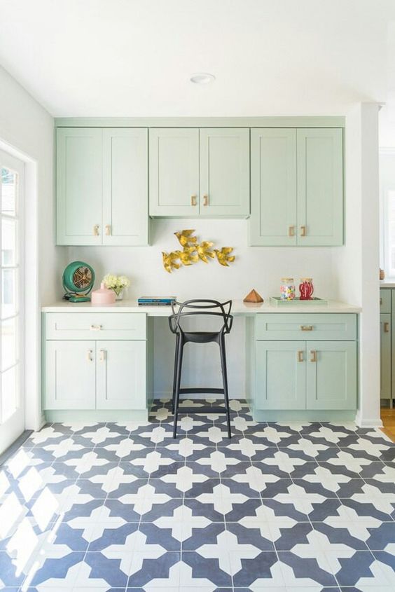 a mint green working space with kitchen cabinets, some decor and a tall stool is a lovely addition to your kitchen, done in the same style