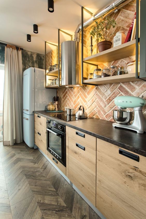 an industrial kitchen with stained flat panel cabinets, a brick herringbone backsplash, suspended open shelves and exposed pipes