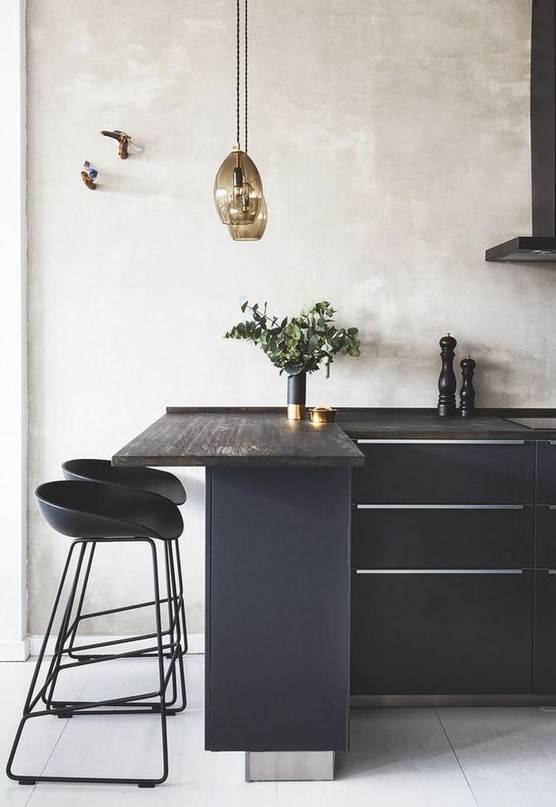 a black kitchen refreshed with neutral plaster walls and a white tile floor has a totally different look than a solid black one
