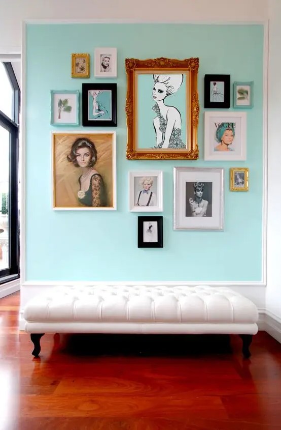 a refined entryway with a mint colored statement wall and a gallery wall looks refreshing