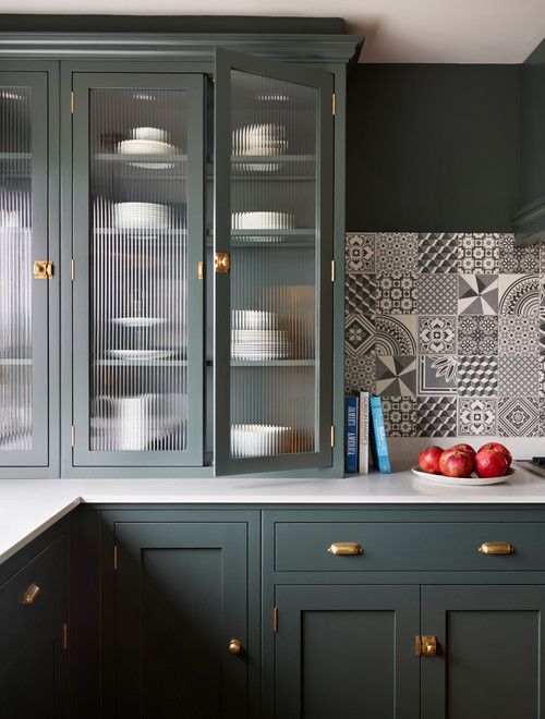 https://www.digsdigs.com/photos/2023/02/a-beautiful-green-kitchen-with-shaker-cabinets-and-fluted-glass-ones-with-a-black-and-white-printed-tile-backsplash-and-brass-touches.jpg