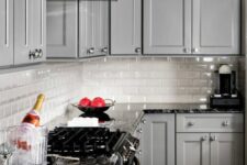 a cute grey kitchen with granite countertops