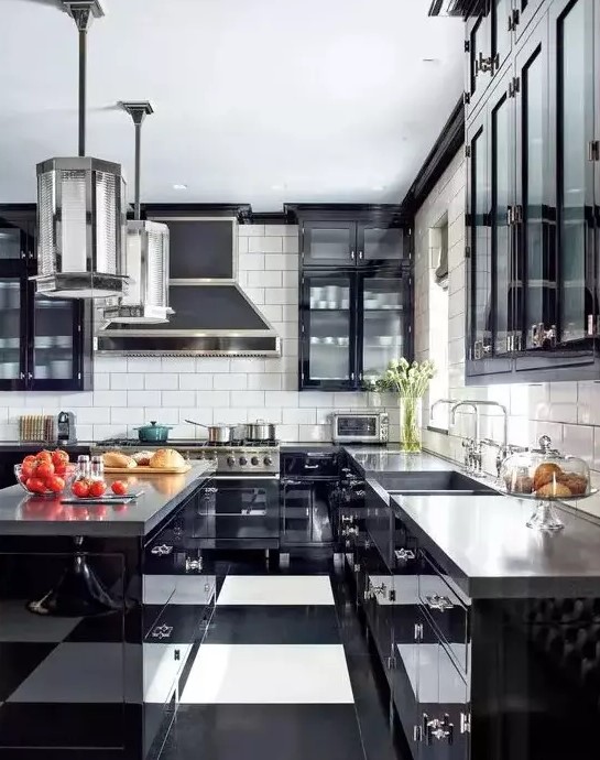 a bold art deco black and white kitchen with black cabinets with glass fronts, a striped floor, glossy black cabinets and concrete countertops