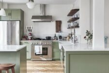 a chic contemporary kitchen in sage green and white, with dark wooden touches and white countertops is very welcoming