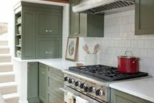 a classic sage green kitchen with shaker cabinets, a white square tile backsplash, white countertops and stainless steel appliances