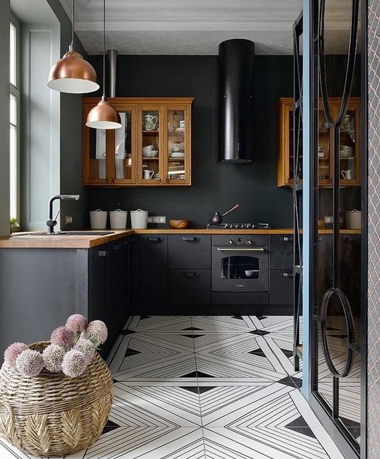 a cozy eclectic kitchen done with rich-colored cabinets and countertops, with copper pendant lamps