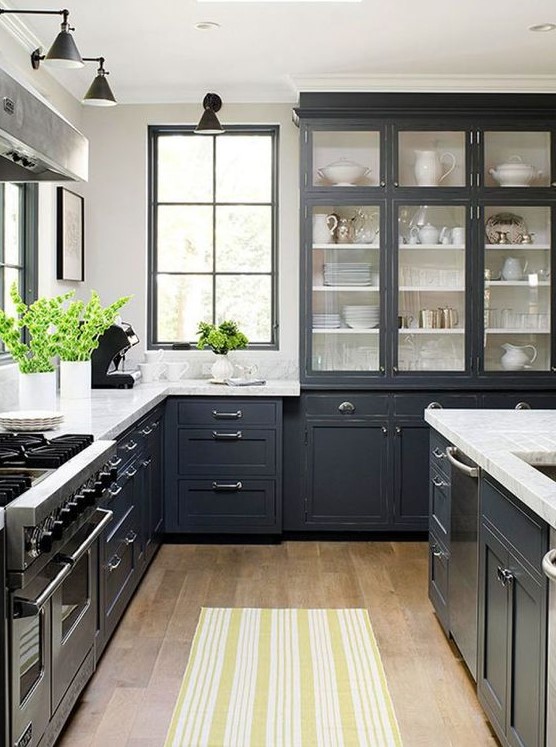a graphite grey traditional kitchen with stainless teel accents and appliances and vintage lamps