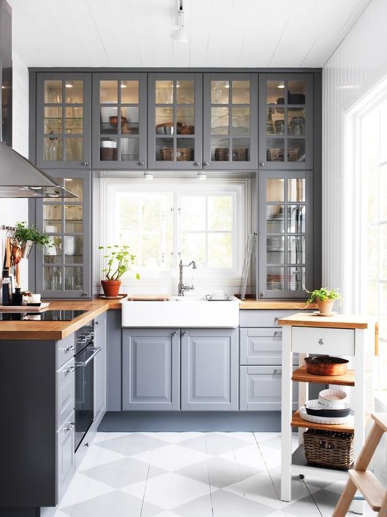 a grey kitchen with wooden countertops and whites and off-whites looks traditional meets modern