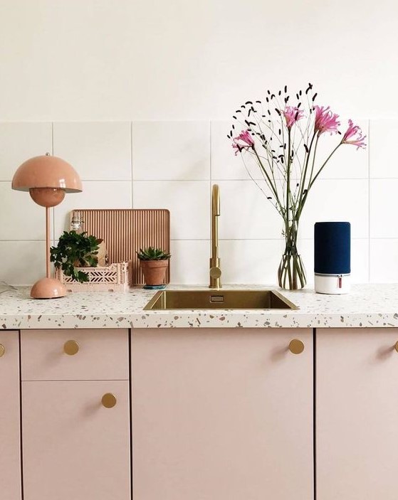 a lovely pink kitchen with white terrazzo countertops and brass touches is a very girlish and pretty idea