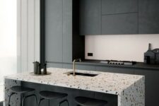 a minimalist black kitchen with sleek no handles cabinets, a gorgeous kitchen island with a terrazzo waterfall countertop and a matching floor