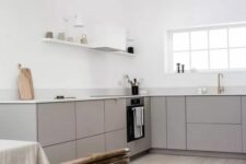 a minimalist grey kitchen with white countertops, open shelves, a white hood, pendant bulbs is a lovely idea