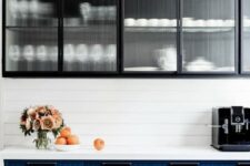 a modern kitchen with a beadboard backsplash