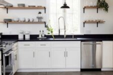 a modern white farmhouse kitchen with shaker cabinets, black soapstone countertops, open shelves instead of cabinets