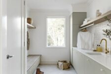 a lovely laundry room with a herringbone floor