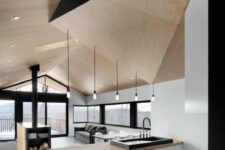 a unique minimalist kitchen done in white, black and light stained wood, a sculptural geometric ceiling is a gorgeous idea and a stylish statement