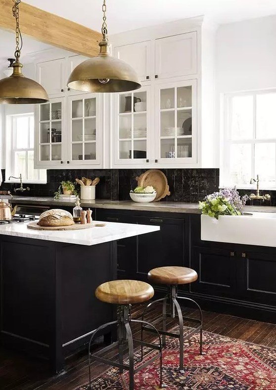 a vintage-inspired kitchen with black shaker cabinets, white countertops and a black Zellige tile backsplash, metal pendant lamps
