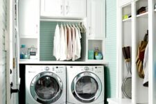 a lovely laundry with a mint accent wall
