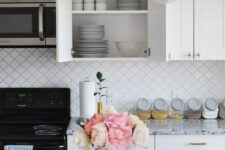a cozy kitchen with a arabesque tile backsplash