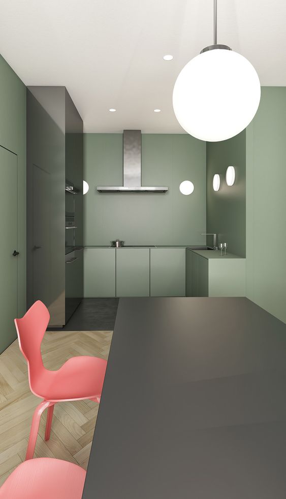 an ultra-minimalist kitchen done in sage green, with built-in appliances and round wall sconces is a bold and catchy idea