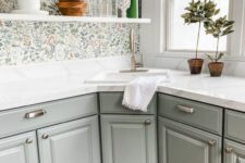 07 a grey farmhouse kitchen with white stone countertops, a floral wallpaper wall, open shelves and potted plants plus brushed sconces