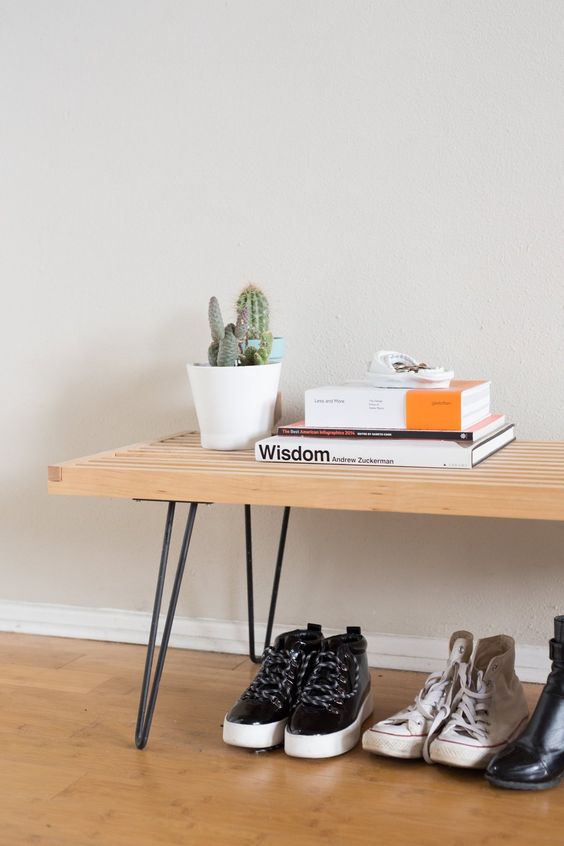 a stylish bench with black hairpin legs is a cool idea for a mid-century modern or boho space, it looks cool