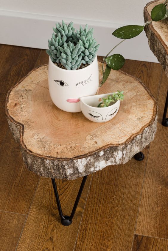 a lovely side table of a tree slice and black hairpin legs is a cool rustic piece that you can make yourself