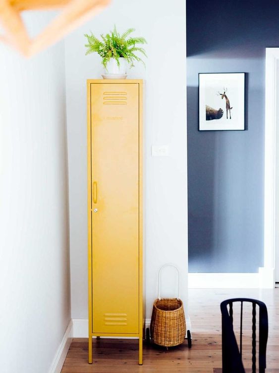 a small bright yellow locker placed somewhere in an awkward corner will give you enough storage space and will add a touch of color
