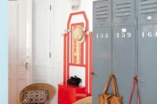 12 an eclectic space with grey metal lockers, a bold red console table, rattan chairs, bold bags and bright decor on top the lockers