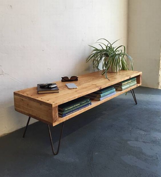 a console table with a storage compartment, with hairpin legs and some books plus a potted plant for a mid-century modern space