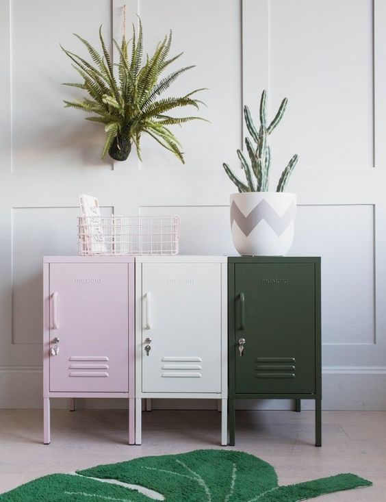 an arrangement of pink, creamy and dark green lockers is a stylish storage idea for any space, and the colors will add eye-catchiness