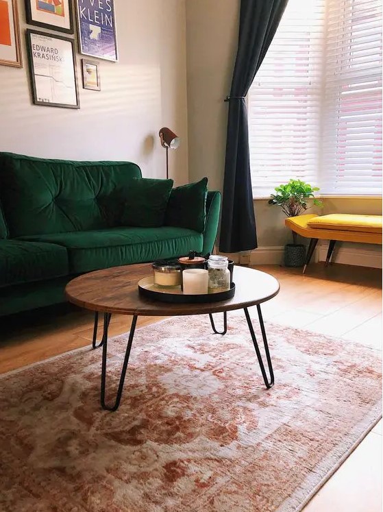 a cool mid-century modern coffee table with a rich stained round tabletop and hairpin legs is pure elegance and timeless style for your living room