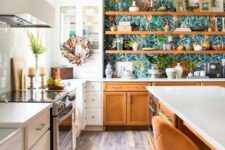 18 a beautiful white and stained kitchen with shaker cabinets, open shelving and glass front cabinets, white stone countertops and floral wallpaper as backing for the shelves