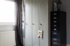 18 a kid’s space finished off with grey lockers, with black flie cabinets that provide a lot of storage space