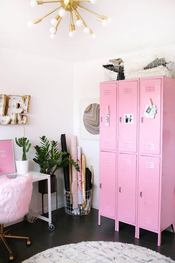 a lovely glam home office with hot pink lockers, a desk with casters and a pink fur chair, some gold touches and decor