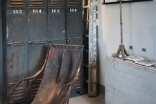 20 an industrial space with shabby chic black metal lockers, a leather rocker chair, an artwork and a folding shabby chic table