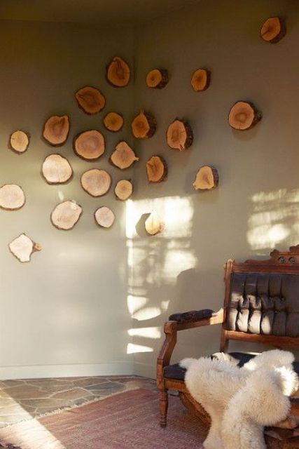 a creative and cool wall art of tree slices going from one wall to another is a cool and beautiful decor idea in rustic style