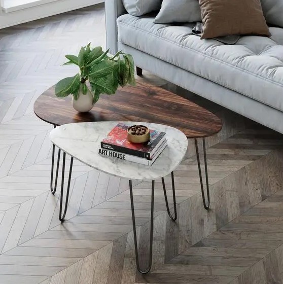 a duo of mid-century modern coffee tables, with a rich-stained wood and white stone tabletops and hairpin legs is cool