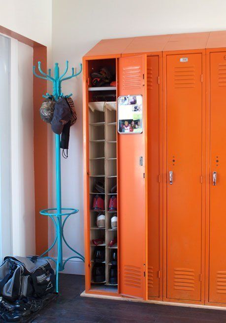 a mudroom with bold orange lockers and a blue rack is a cool and bright space, and these colors raise the spirits