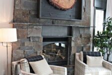 22 a fantastic rustic wall art of a large tree slice in a black frame hung over the fireplace is an amazing addition here