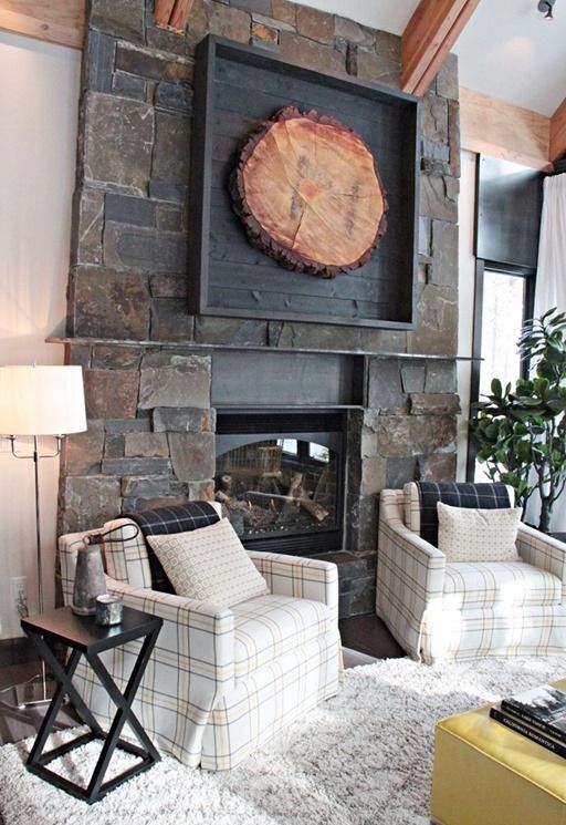 a fantastic rustic wall art of a large tree slice in a black frame hung over the fireplace is an amazing addition here