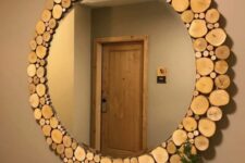 24 a round mirror with a frame made of tree slices is a gorgeous rustic decor idea for your entryway or for a rustic bathroom