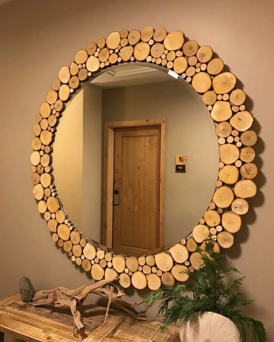 a round mirror with a frame made of tree slices is a gorgeous rustic decor idea for your entryway or for a rustic bathroom