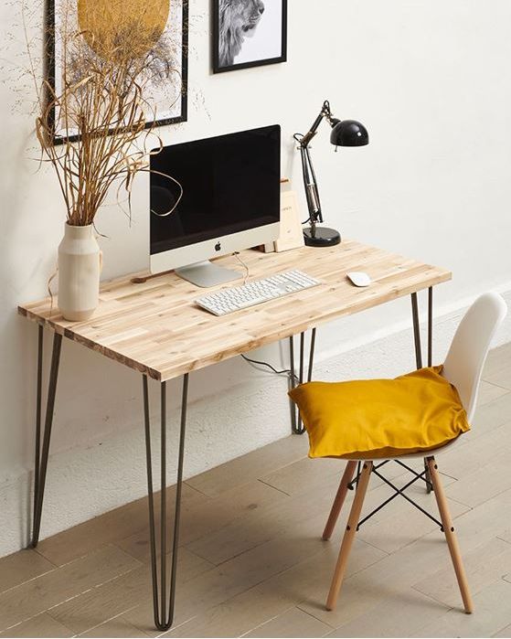 a lightweight hairpin leg desk, a white chair with a pillow, a black table lamp and a mini gallery wall are great for working