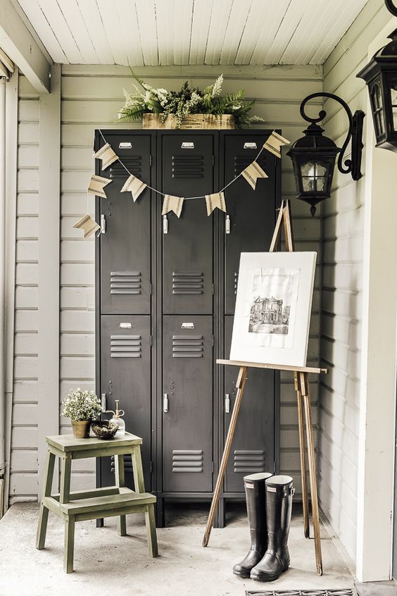 a porch with graphite grey lockers, a ladder, an artwork, greenery, buntings and rubber boots - store outdoor stuff in these lockers